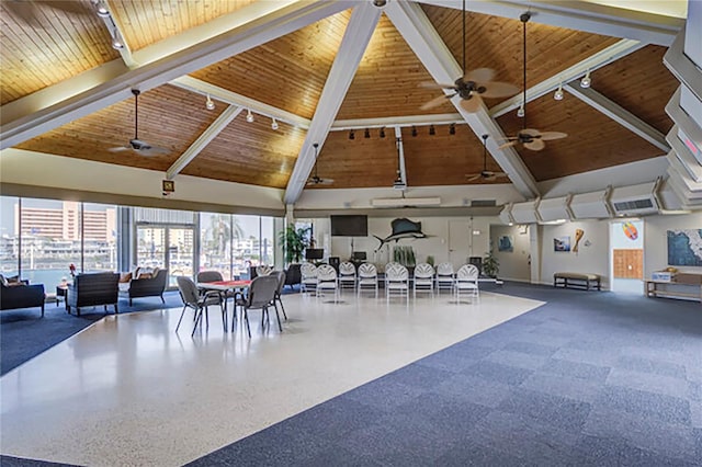 interior space featuring wooden ceiling, beam ceiling, high vaulted ceiling, and track lighting