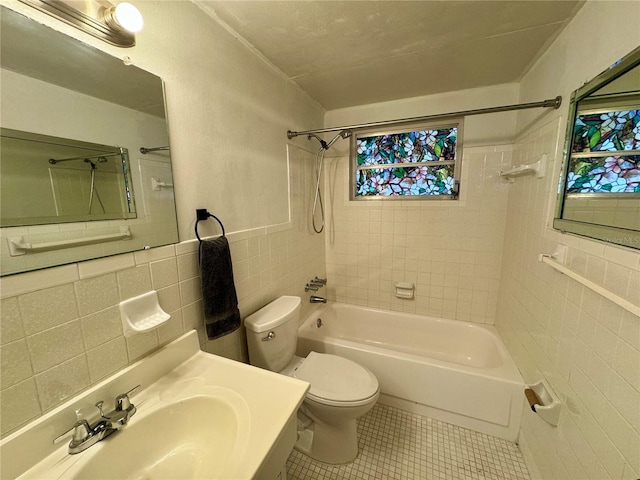 full bathroom featuring backsplash, toilet, tile walls, tile patterned floors, and tiled shower / bath