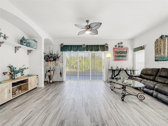 living room featuring ceiling fan and light wood-type flooring