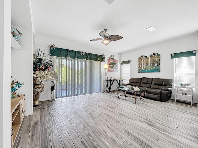 living room with ceiling fan, a healthy amount of sunlight, and light hardwood / wood-style floors