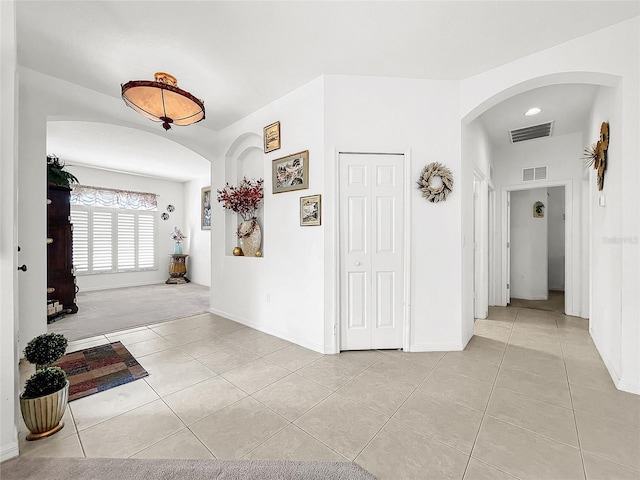 hall featuring light tile patterned floors