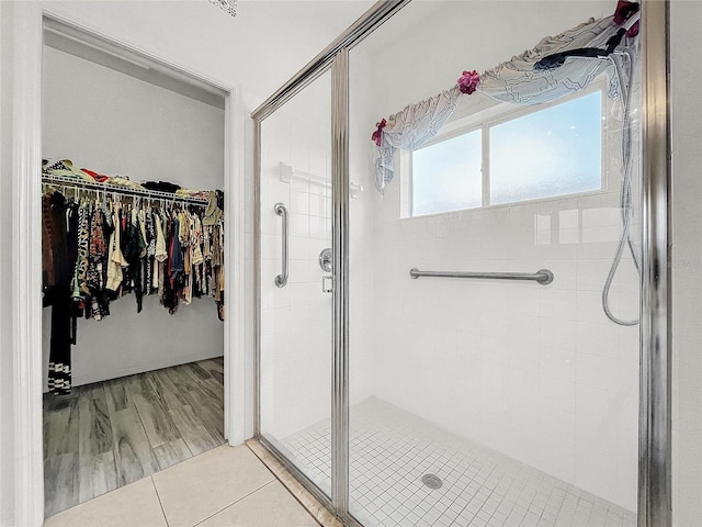 bathroom with tile patterned flooring and a shower with door