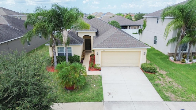 view of front of house featuring a garage and a front yard