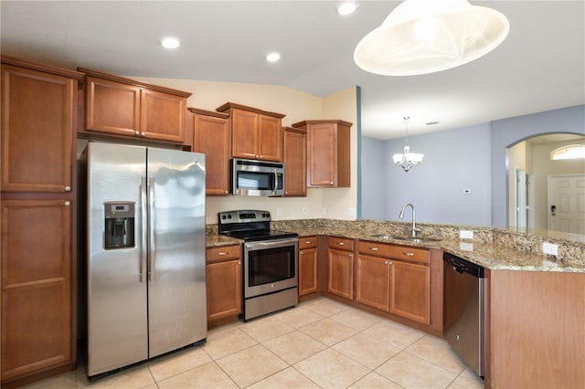 kitchen with sink, decorative light fixtures, light tile patterned floors, stainless steel appliances, and kitchen peninsula