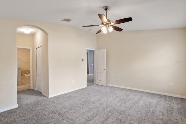 carpeted spare room with ceiling fan and lofted ceiling