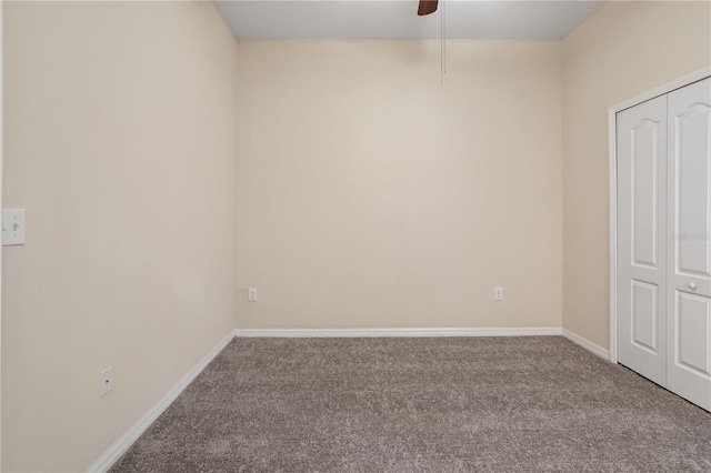 empty room with ceiling fan and carpet flooring