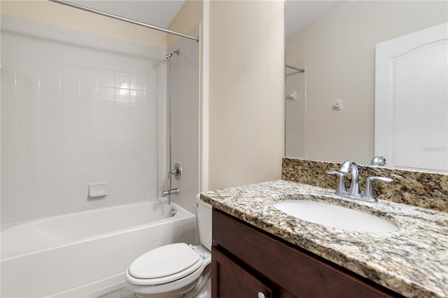 full bathroom featuring toilet, tiled shower / bath, and vanity