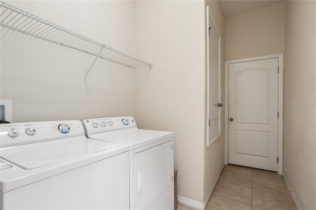 clothes washing area with separate washer and dryer and light tile patterned floors