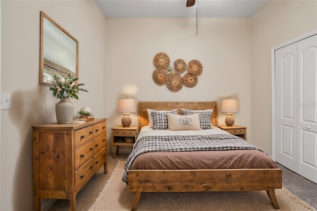 carpeted bedroom with ceiling fan and a closet