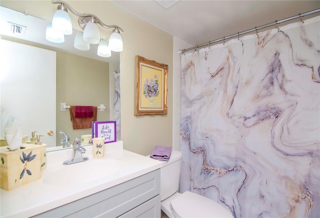 bathroom featuring vanity, curtained shower, and toilet