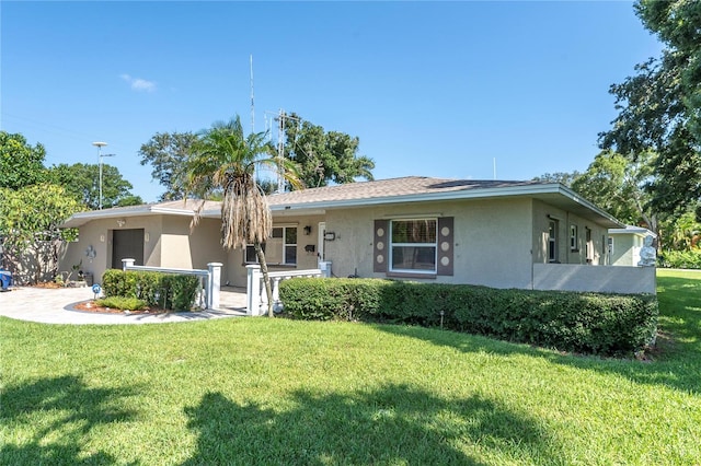 ranch-style home with a front lawn