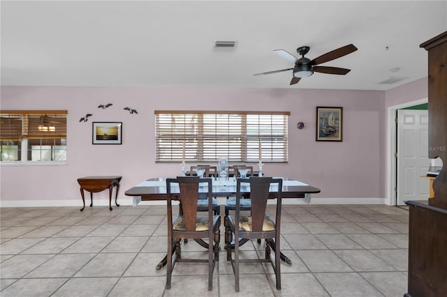 tiled dining area with ceiling fan