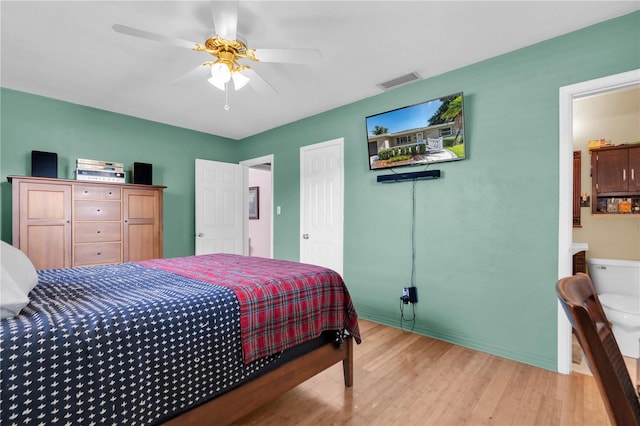 bedroom featuring ceiling fan, connected bathroom, and light hardwood / wood-style flooring