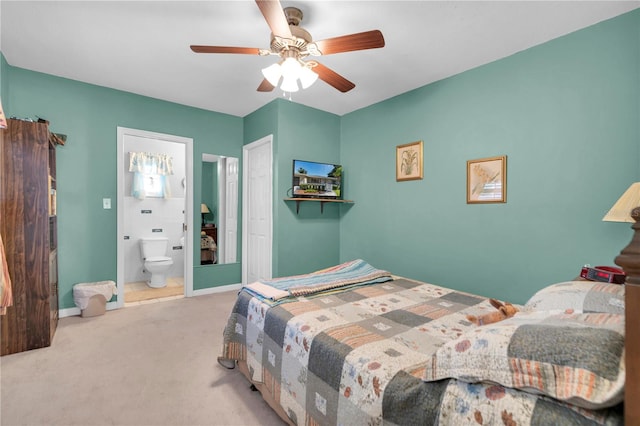 carpeted bedroom featuring ceiling fan and ensuite bathroom