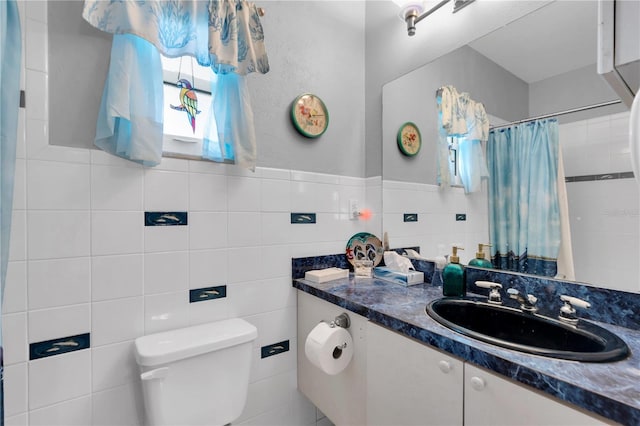 bathroom featuring tile walls, toilet, and vanity