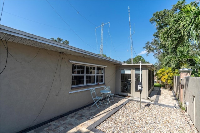 view of side of property with a patio