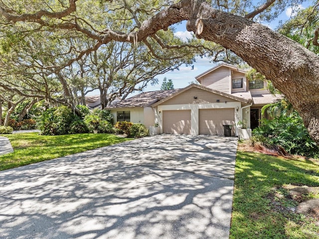 view of front of home with a garage and a front yard