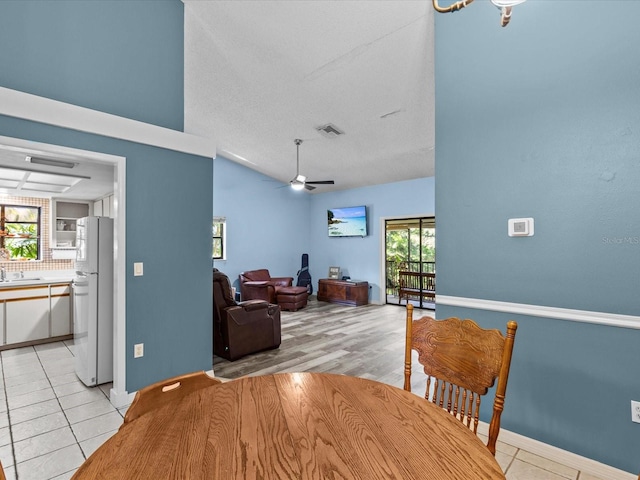 dining space featuring a wealth of natural light, ceiling fan, and light tile patterned floors