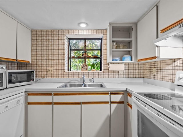 kitchen featuring sink, white cabinets, tasteful backsplash, and white appliances