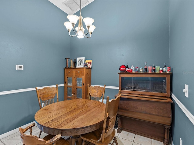 dining space with a chandelier and light tile patterned floors