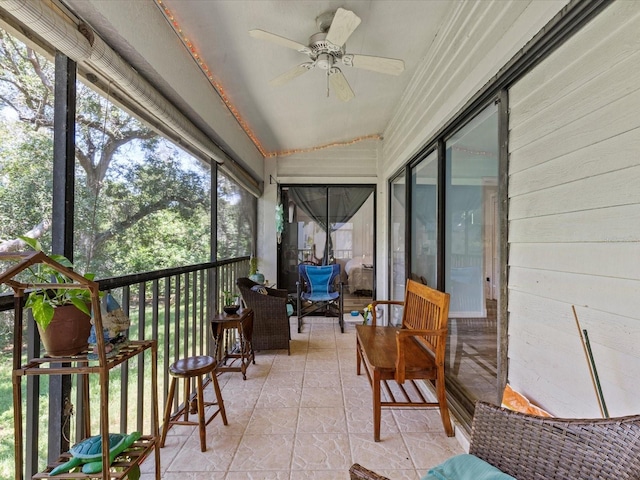 sunroom with ceiling fan and vaulted ceiling