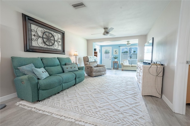 living room with ceiling fan and light hardwood / wood-style floors