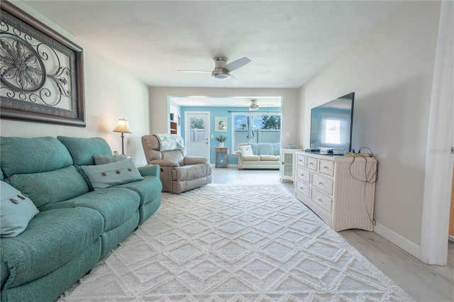 living room with ceiling fan and light hardwood / wood-style floors