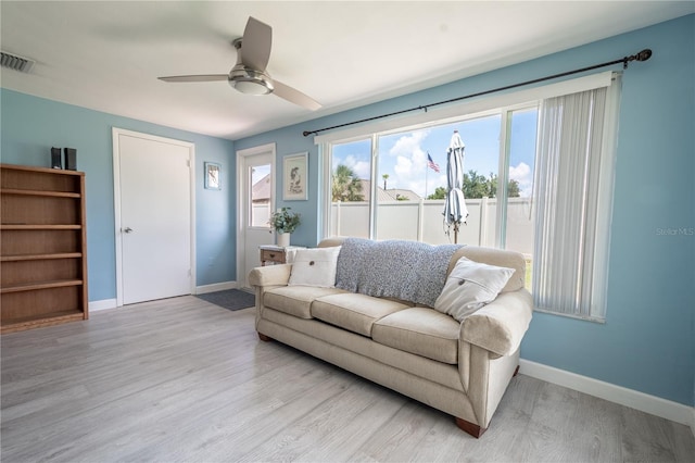 living room featuring light hardwood / wood-style floors and ceiling fan