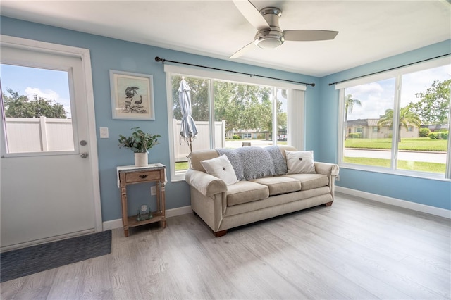 interior space featuring a wealth of natural light, ceiling fan, and light hardwood / wood-style floors