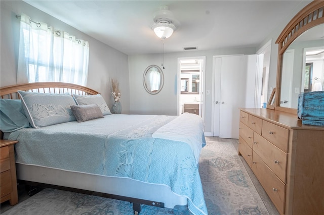 bedroom featuring ceiling fan and ensuite bathroom