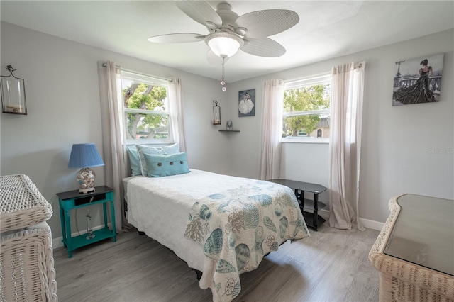 bedroom with light hardwood / wood-style floors and ceiling fan