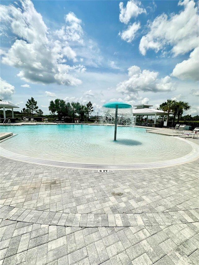 view of swimming pool featuring pool water feature