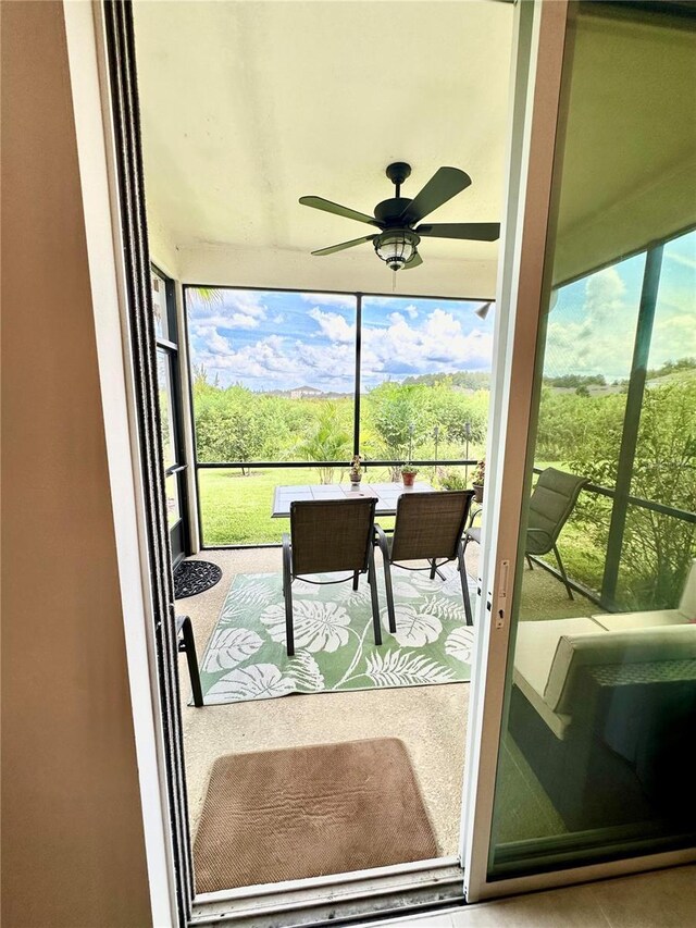 sunroom / solarium with ceiling fan and plenty of natural light