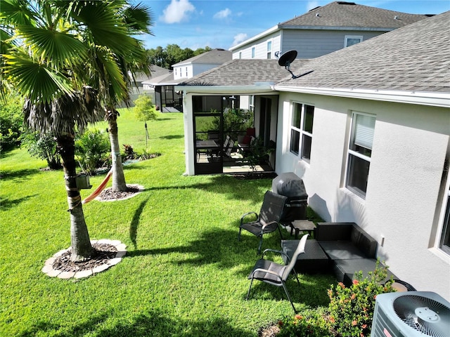 view of yard featuring central AC and a sunroom