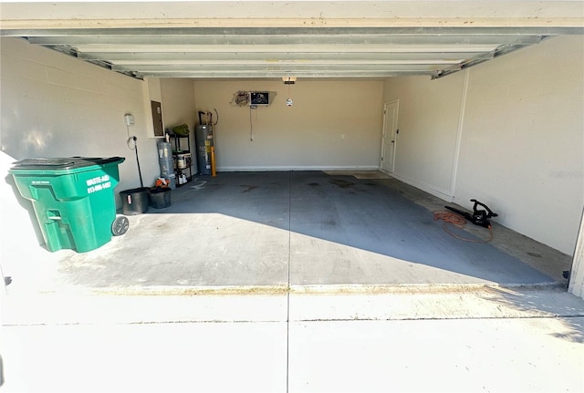 garage with electric panel and water heater