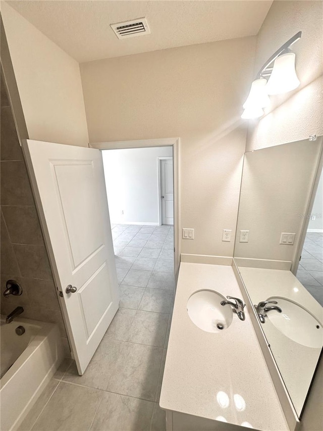 bathroom with tile patterned floors, vanity, and shower / tub combination