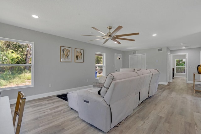 home theater room featuring ceiling fan and light wood-type flooring