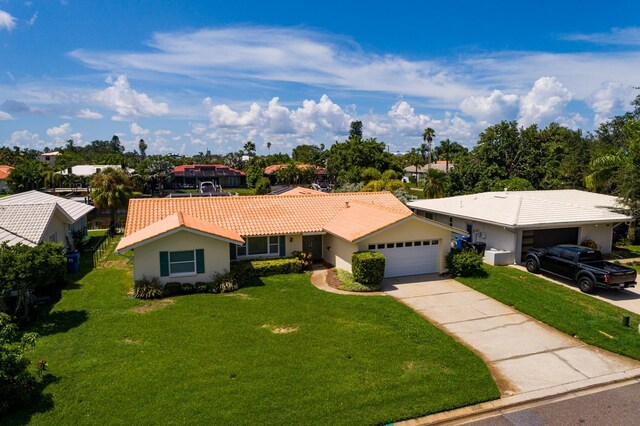 single story home with a front yard and a garage