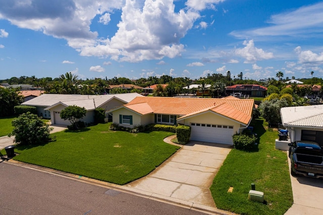 ranch-style home featuring a tile roof, a front yard, a garage, a residential view, and driveway