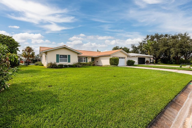 single story home featuring a garage and a front lawn