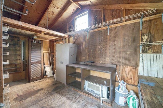 below grade area featuring wooden walls, a workshop area, wooden ceiling, and hardwood / wood-style floors