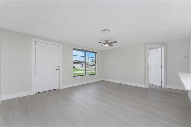 unfurnished living room with a ceiling fan, baseboards, visible vents, and light wood finished floors