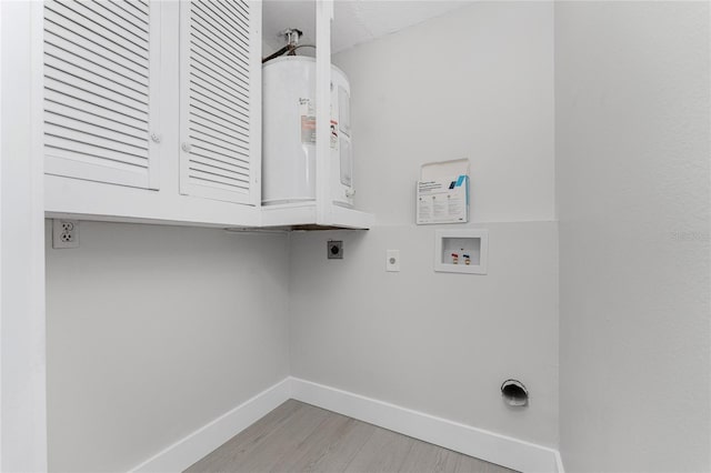 laundry area featuring baseboards, light wood-style flooring, cabinet space, electric dryer hookup, and washer hookup