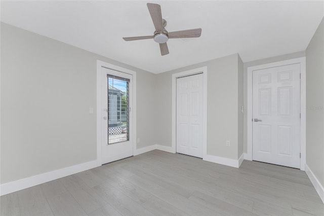 unfurnished bedroom with access to outside, a closet, light wood finished floors, baseboards, and ceiling fan