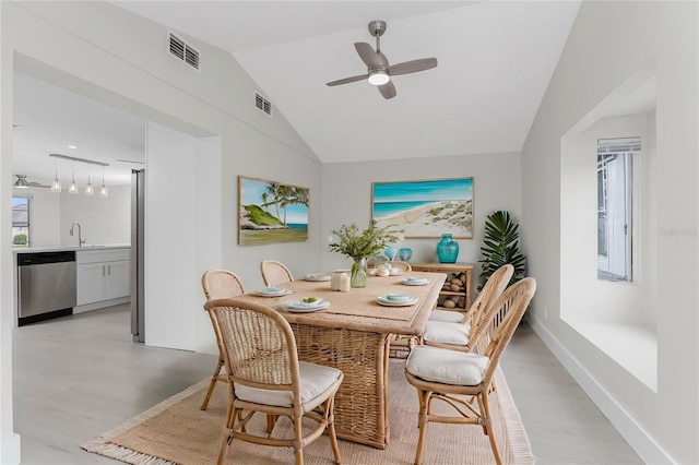 dining space with lofted ceiling, light wood-style floors, visible vents, and ceiling fan