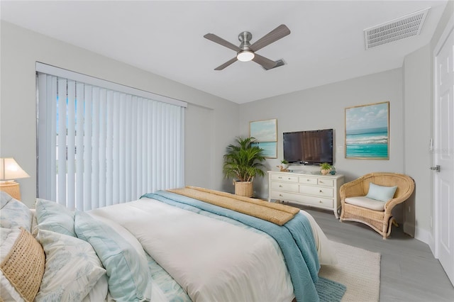 bedroom featuring visible vents, a ceiling fan, and wood finished floors