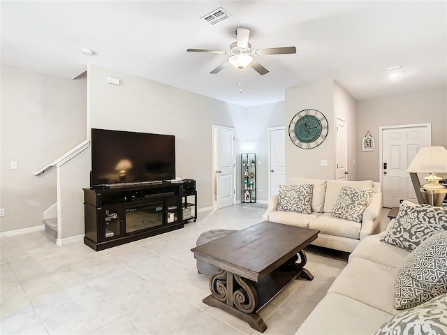 tiled living room featuring ceiling fan