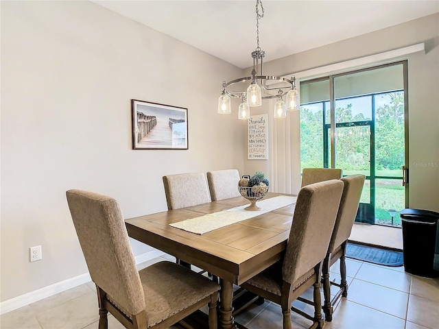 dining area featuring light tile patterned floors and an inviting chandelier