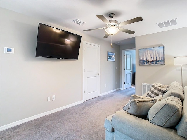 carpeted living room with ceiling fan