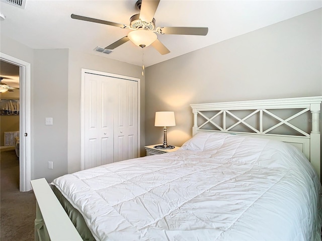 carpeted bedroom featuring ceiling fan and a closet